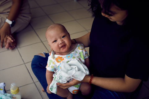 'May' with her baby boy at the Bangkok Emergency Home  © UNFPA / Ruth Carr