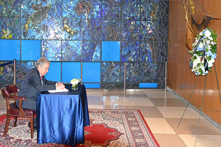 U.N. Secretary-General Antonio Guterres signing the book of condolences.